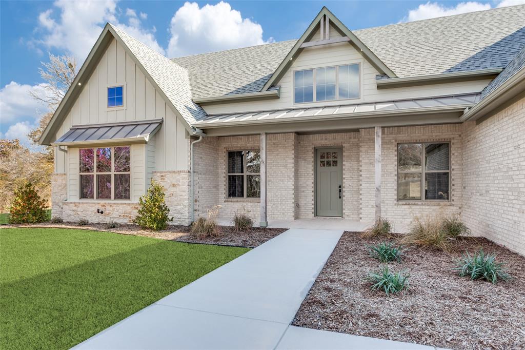 182 Fan Mill Trail Weatherford, TX 76085 - Photo 3 of 31 a front view of a house with a garden and plants