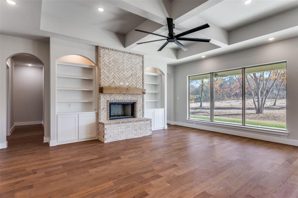 182 Fan Mill Trail Weatherford, TX 76085 - Photo 6 of 31 a view of an empty room with a fireplace and a window