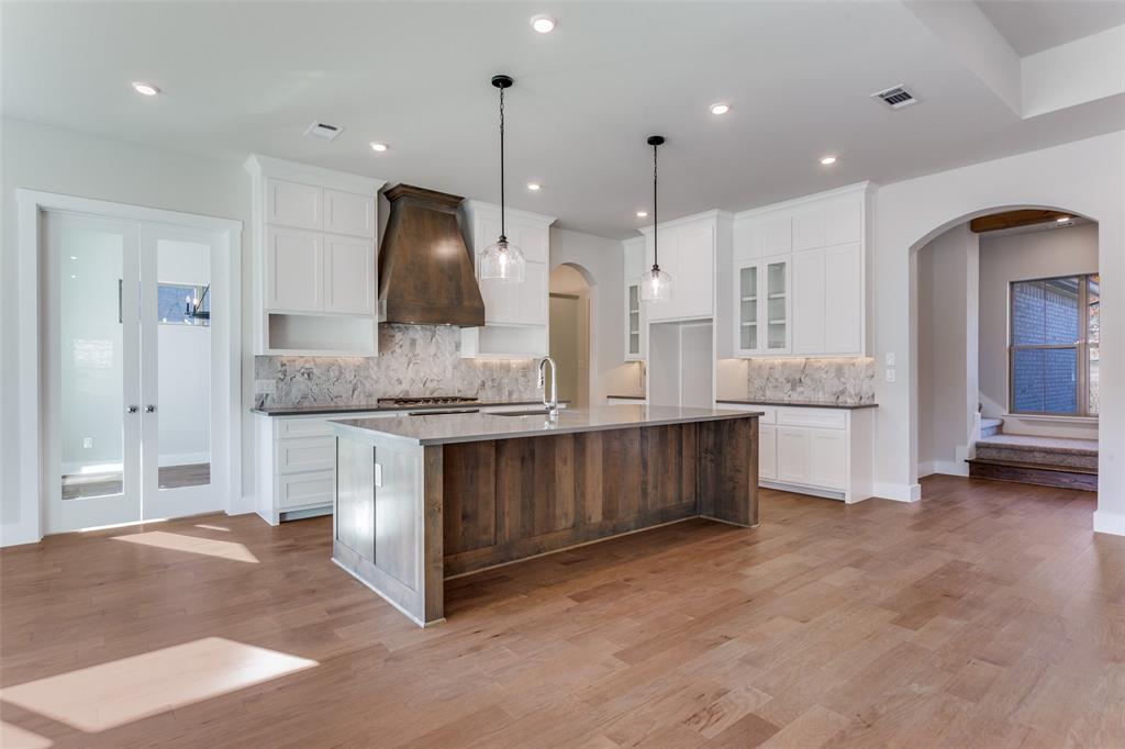 182 Fan Mill Trail Weatherford, TX 76085 - Photo 7 of 31 a large kitchen with a large counter top a sink stainless steel appliances and cabinets