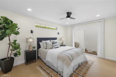 a bedroom with a large bed and a chandelier
