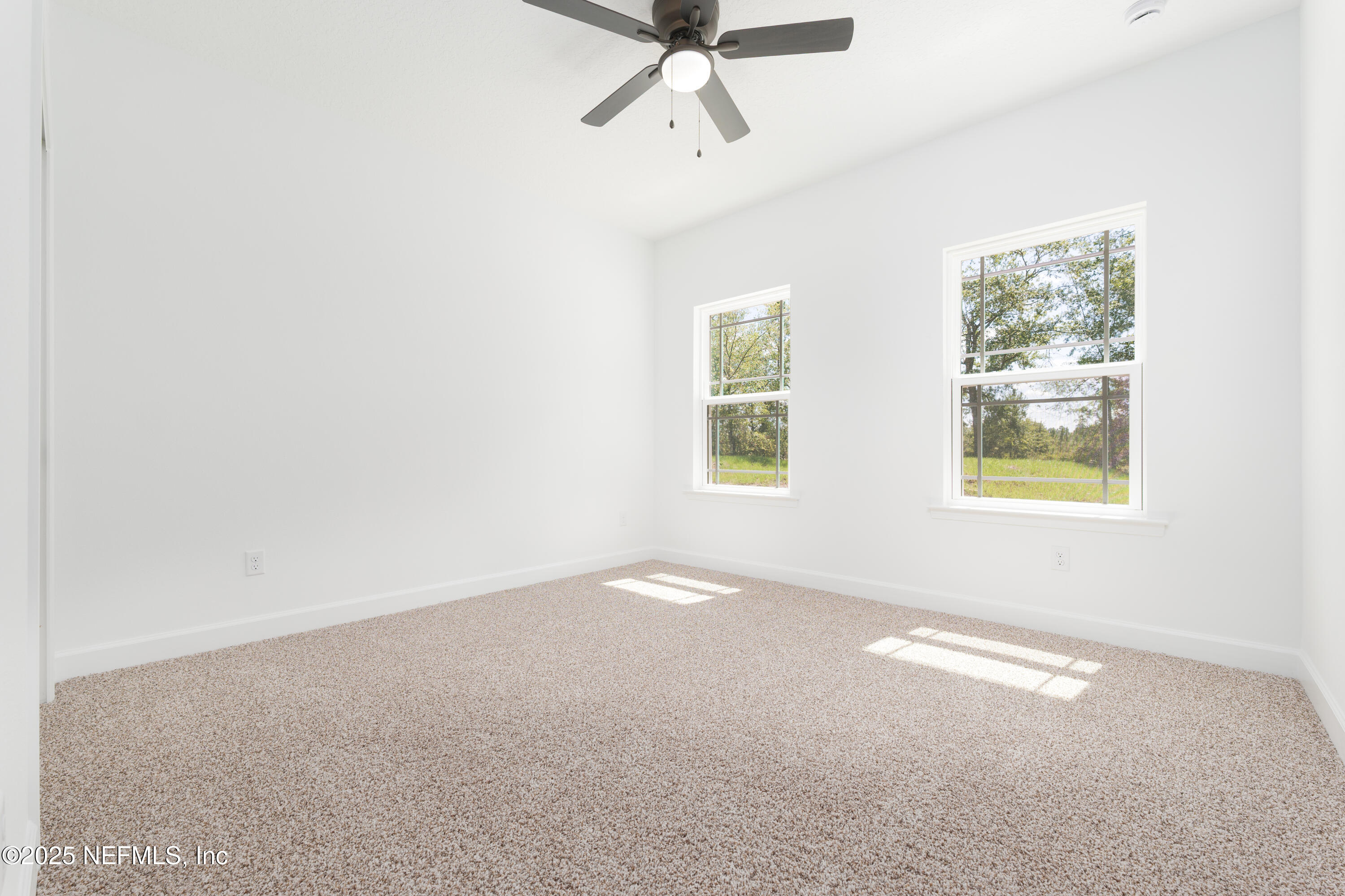 5294 County Road 352 Keystone Heights, FL 32656 - Photo 18 of 23 an empty room with windows and ceiling fan