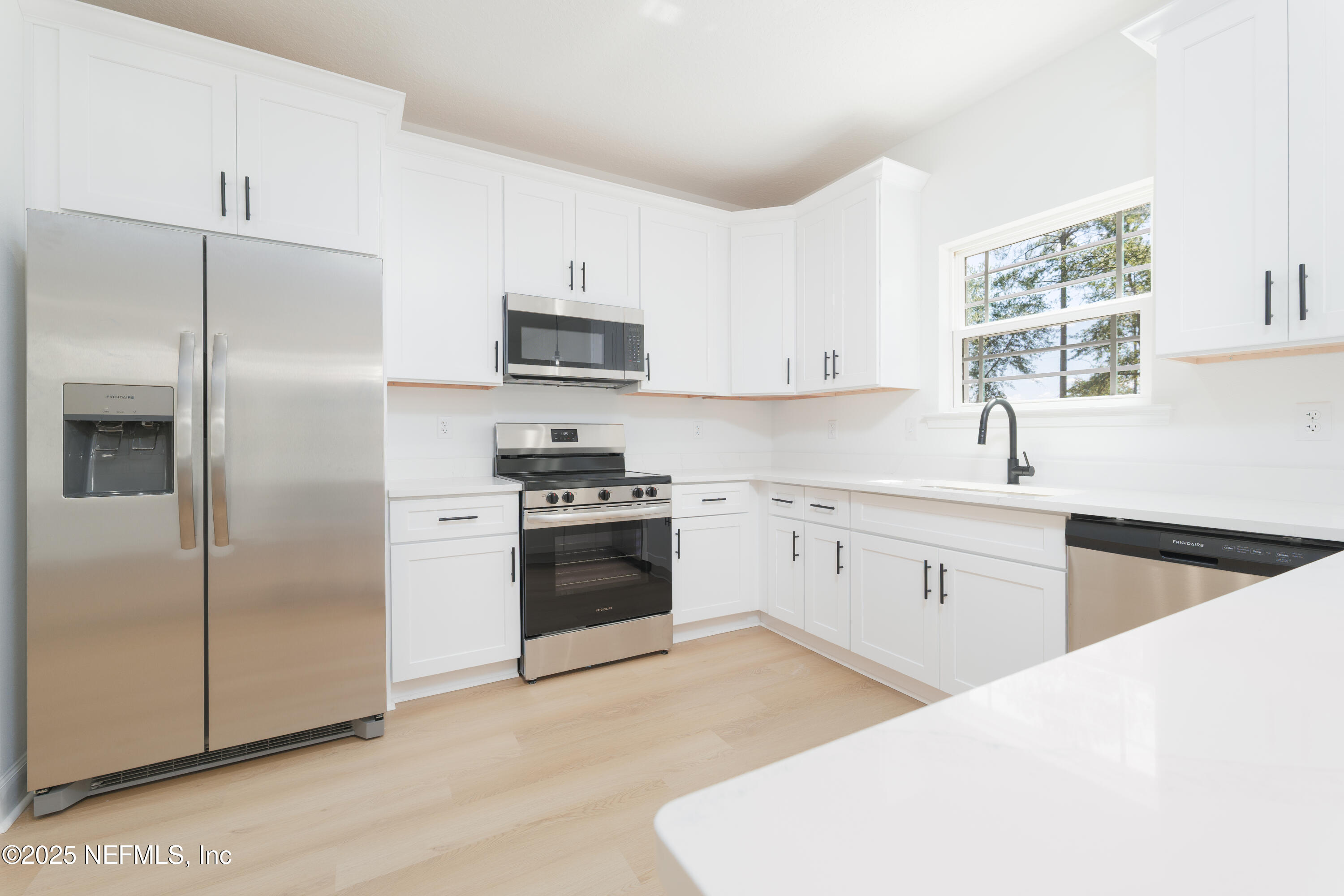 5294 County Road 352 Keystone Heights, FL 32656 - Photo 6 of 23 a kitchen with stainless steel appliances a refrigerator sink and stove