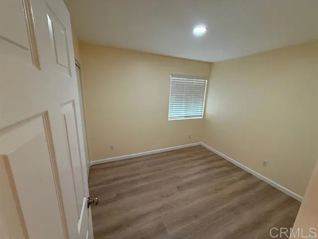 an empty room with a wooden door