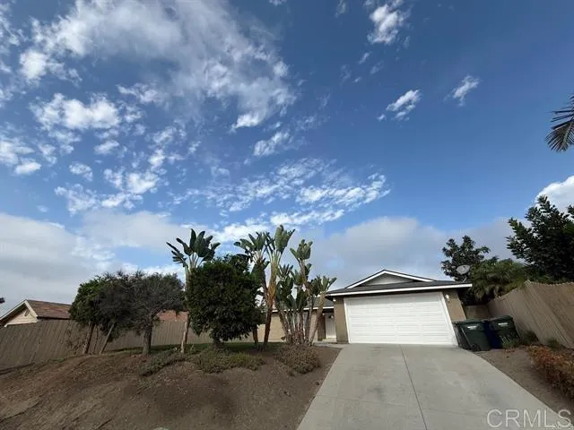 a view of a house with a yard and a garage