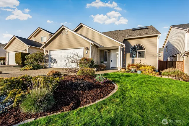 a view of a house with a small yard and plants