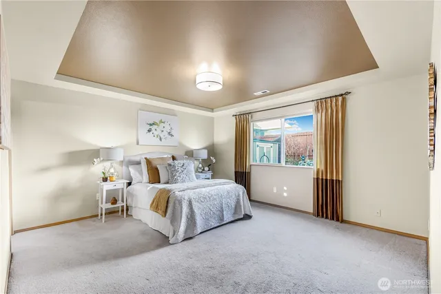 a bedroom with a bed and large window