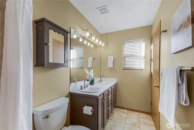 a bathroom with a sink toilet and mirror