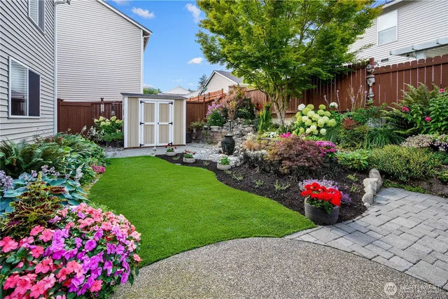 a front view of a house with a yard and fountain