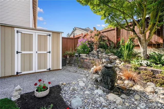 a view of a house with backyard and sitting area