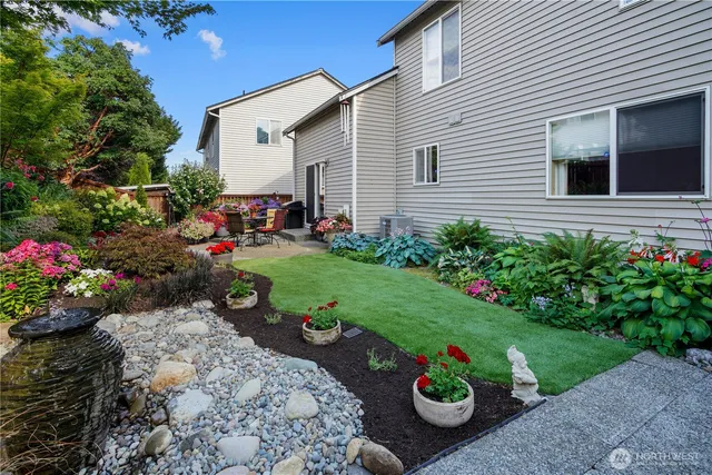 a view of a chair and table in back yard of the house