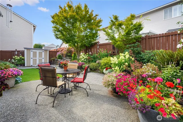 a view of a chairs and table in a backyard