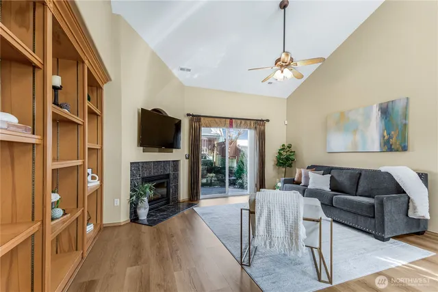 a living room with fireplace furniture and a flat screen tv