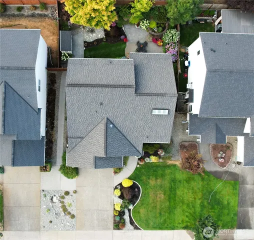 an aerial view of a house with a yard