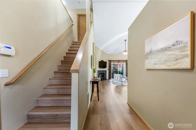 a view of entryway and hall with wooden floor
