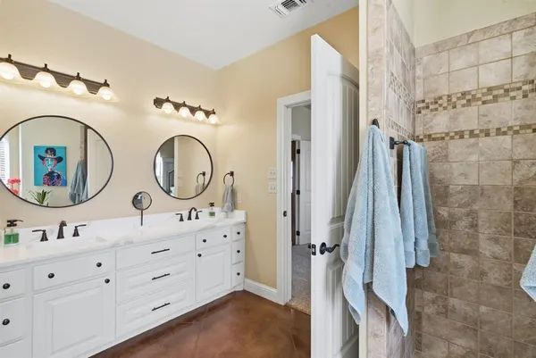 a bathroom with a double vanity sink and a mirror