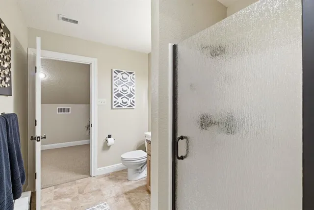 a bathroom with a toilet sink and shower