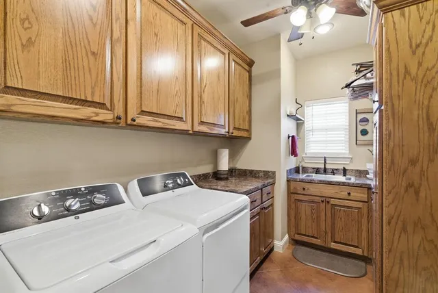 a kitchen with a sink cabinets and appliances