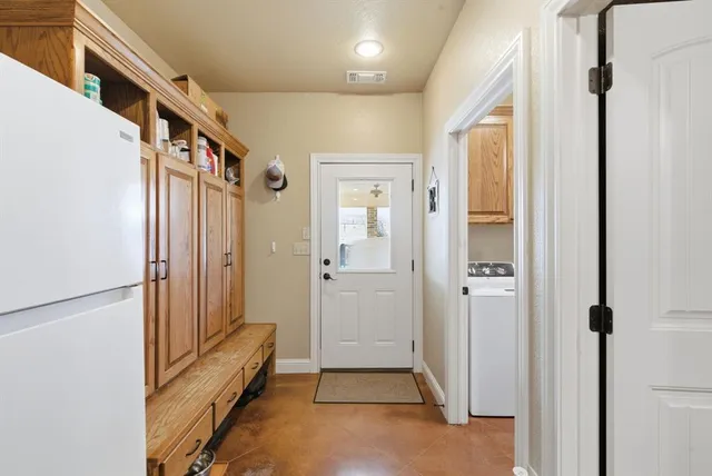 a view of a hallway with a door and staircase