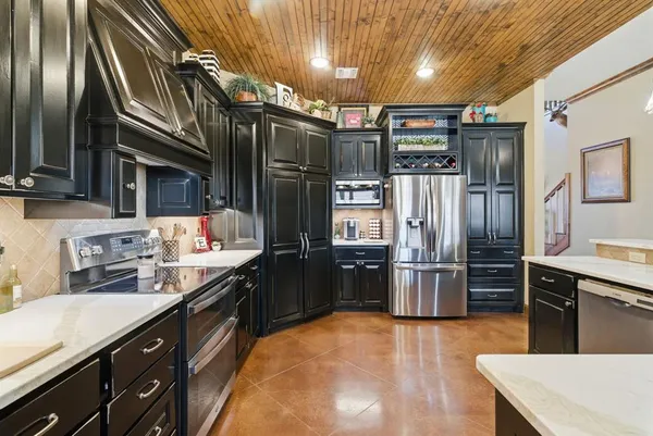 a kitchen with refrigerator and cabinets
