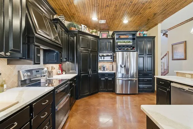 a kitchen with refrigerator and cabinets