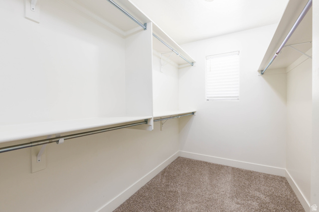 3157 Deseret Drive St. George, UT 84790 - Photo 13 of 24 Walk-in closet featuring built-in shelving, hanging rods, and a window with blinds
