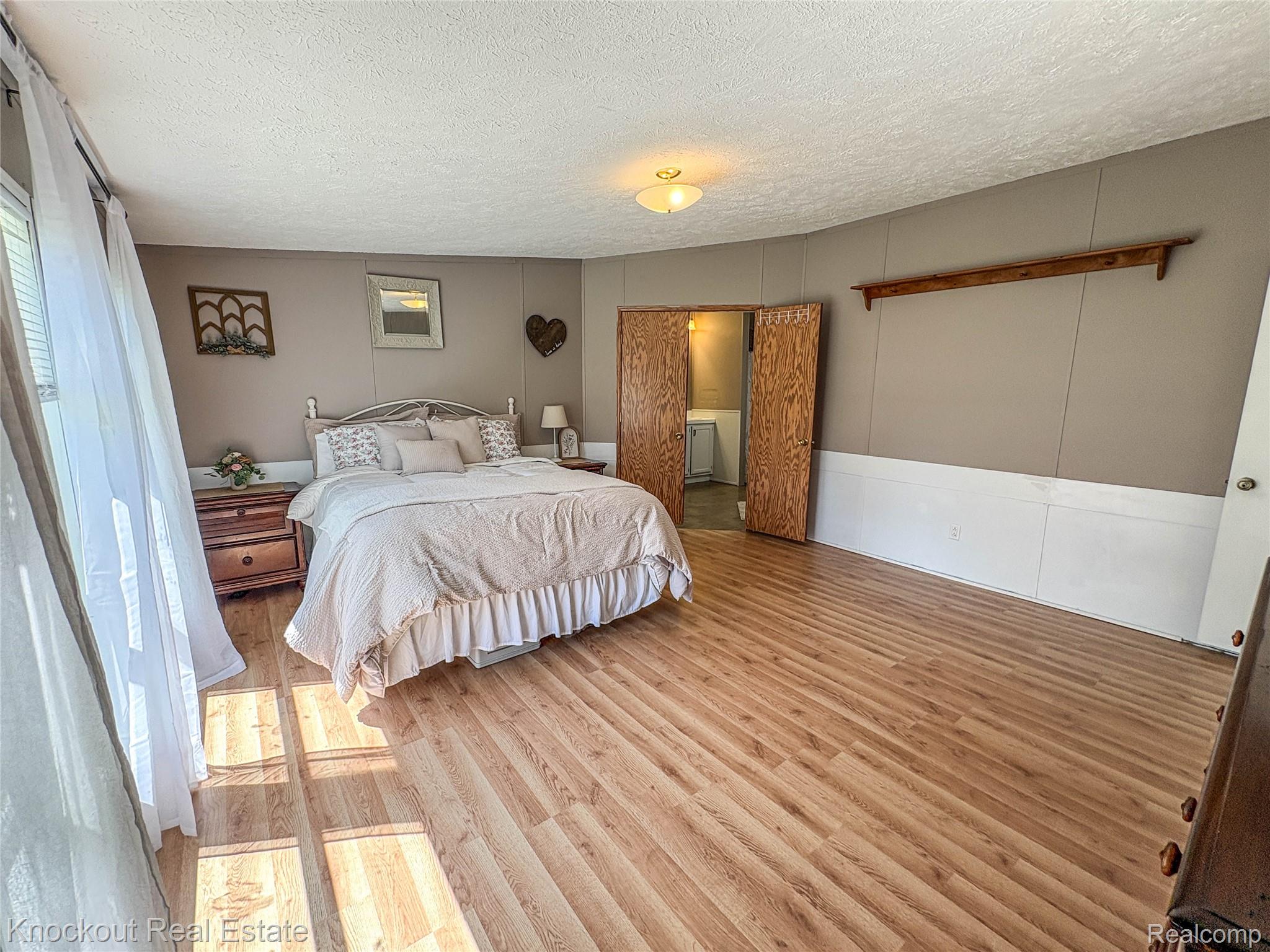 7760 Bell Road Birch Run, MI 48415 - Photo 27 of 68 Spacious room featuring wood-finish flooring and neutral wall tones