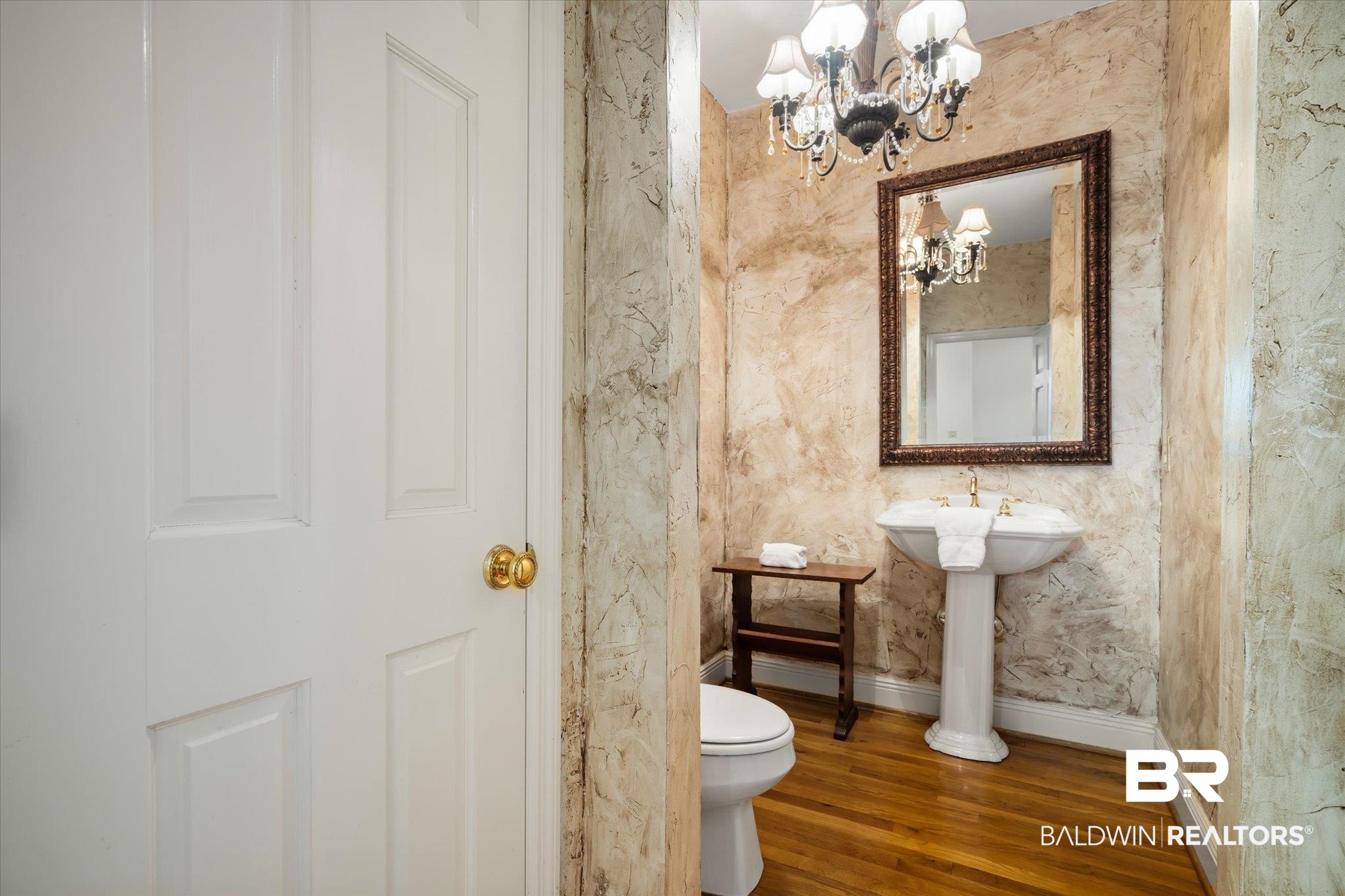 143 Myrtlewood Lane Mobile, AL 36608 - Photo 22 of 55 Bathroom with baseboards, toilet, an inviting chandelier, and wood finished floors