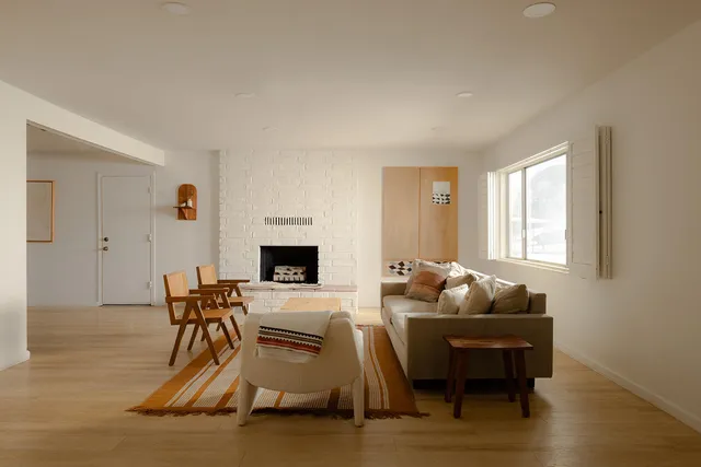 a living room with furniture a fireplace and a table