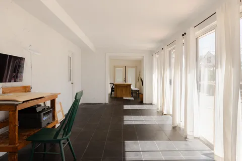 a living room with furniture a fireplace and a window