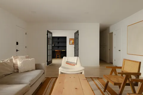 a living room with furniture and white walls