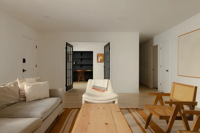 a living room with furniture and white walls