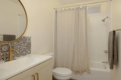 a bathroom with a sink toilet and shower