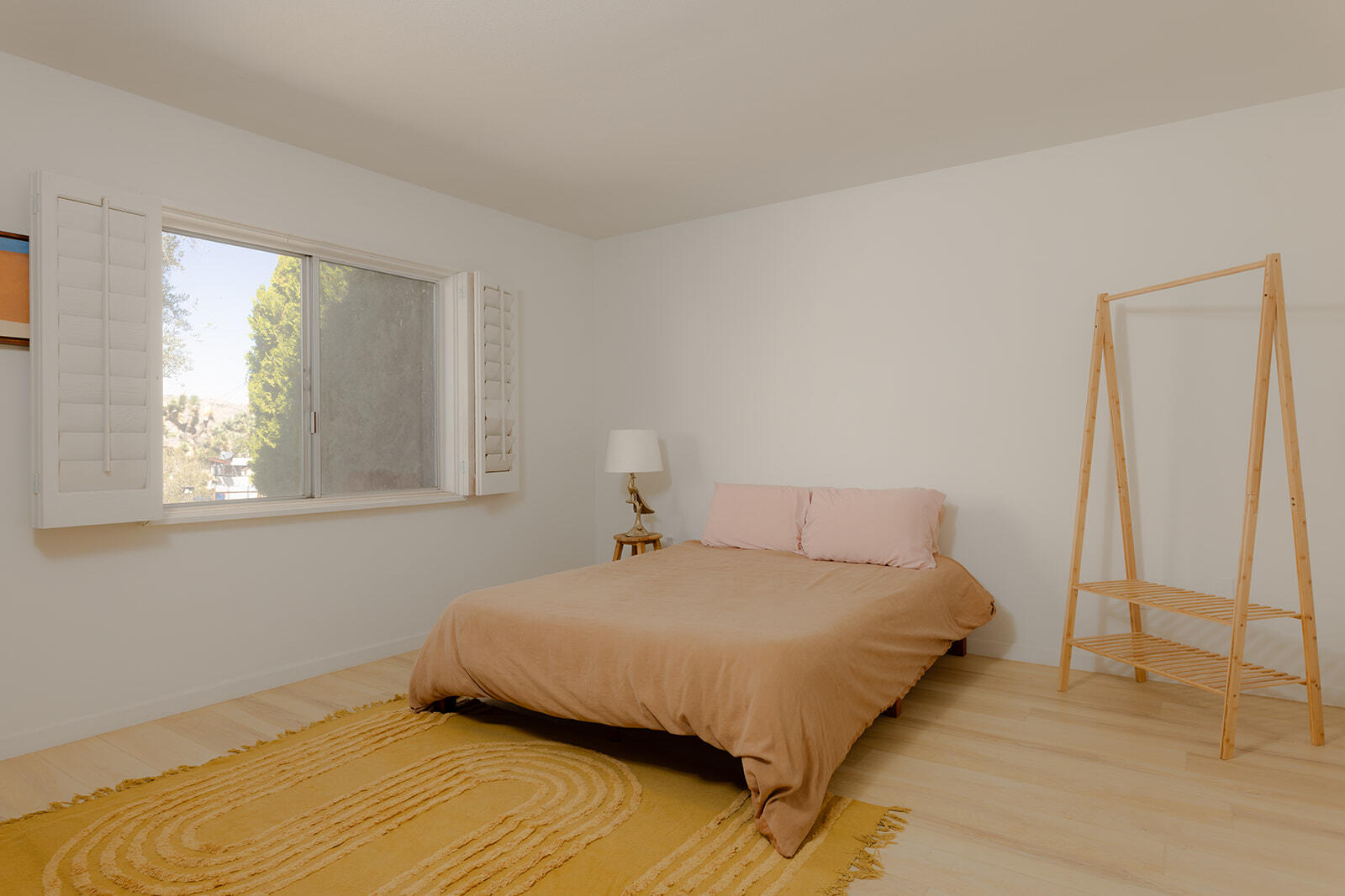 7995 Grand Avenue Yucca Valley, CA 92284 - Photo 16 of 26 a bedroom with a bed and a window