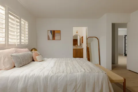 a bedroom with a large bed and a dresser