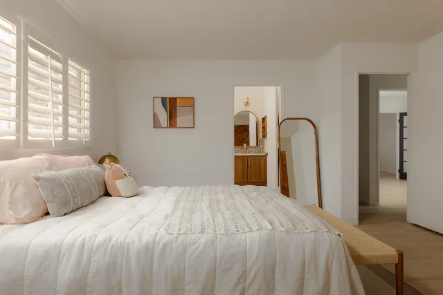 a bedroom with a large bed and a dresser
