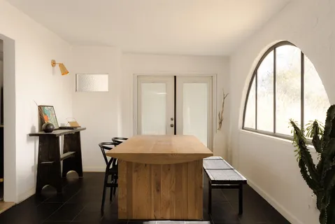 a view of a dining room with furniture and window