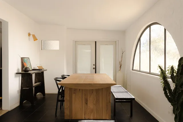 a view of a dining room with furniture and window