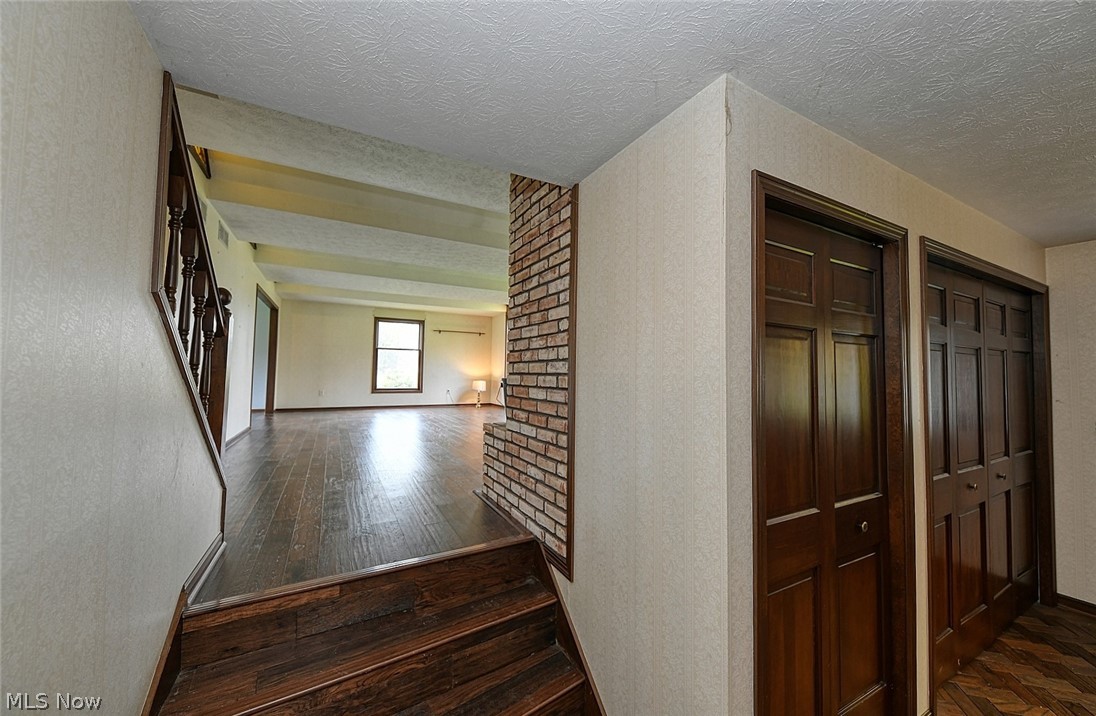 915 Sandy Lake Road Kent, OH 44240 - Photo 12 of 35 Next to the foyer and up a few stairs is the living room with wood burning fireplace and interesting architectural ceiling and some stained glass accents.