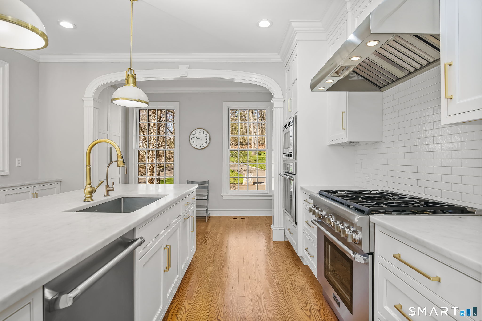 323 Smith Ridge Road New Canaan, CT 06840 - Photo 12 of 39 a kitchen with stainless steel appliances granite countertop a sink stove and cabinets