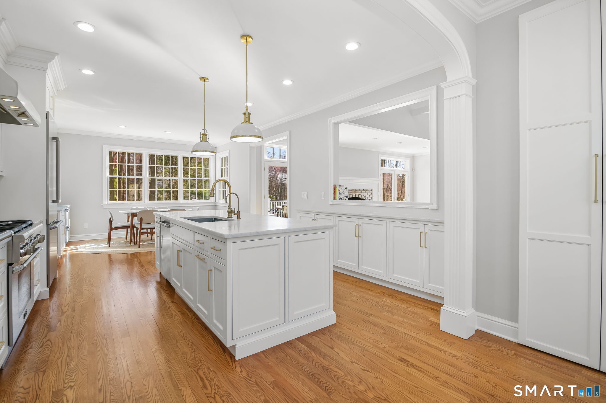 323 Smith Ridge Road New Canaan, CT 06840 - Photo 14 of 39 a kitchen with wooden floors and white walls