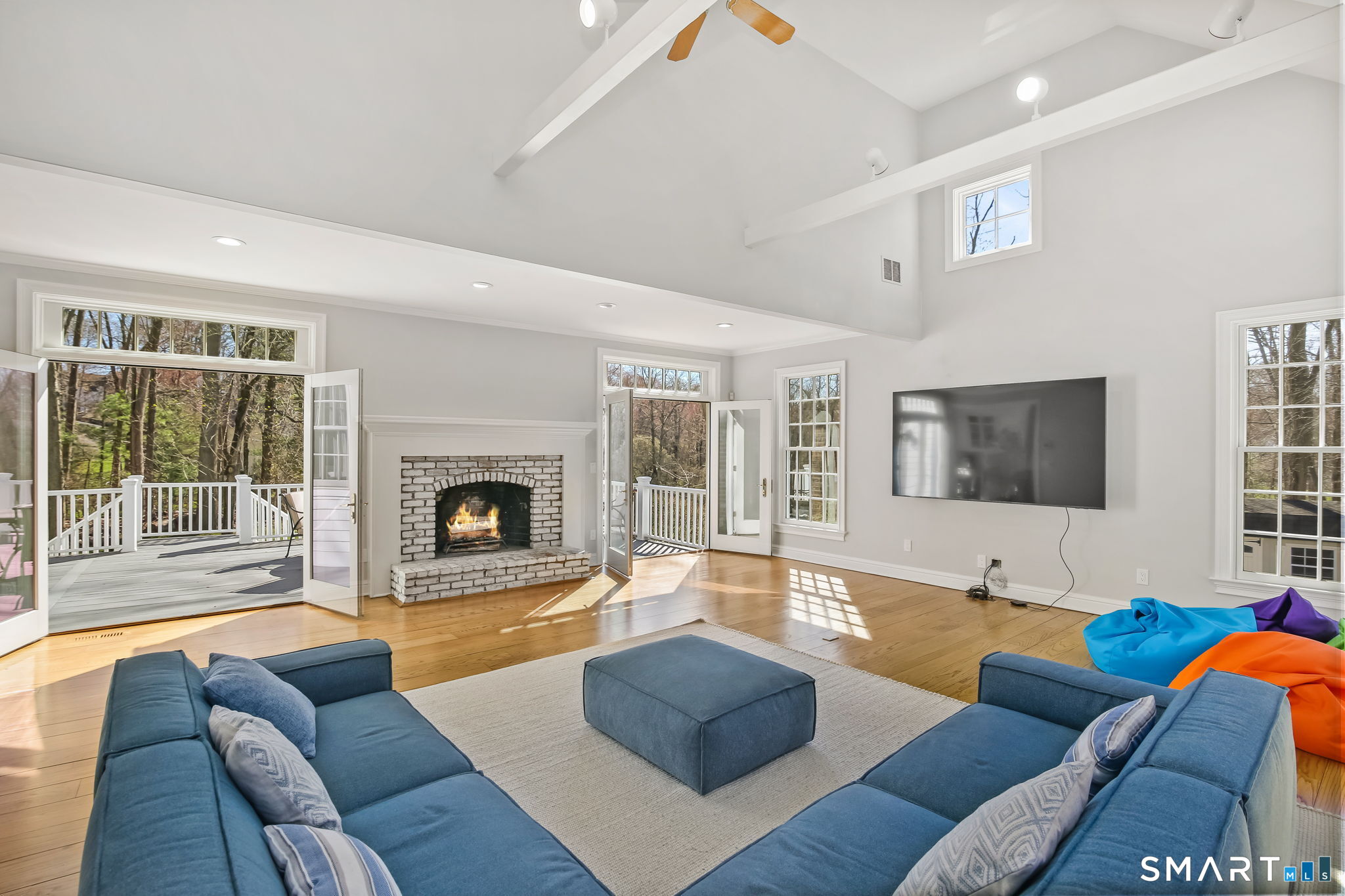 323 Smith Ridge Road New Canaan, CT 06840 - Photo 18 of 39 a living room with furniture and a fireplace with wooden floor