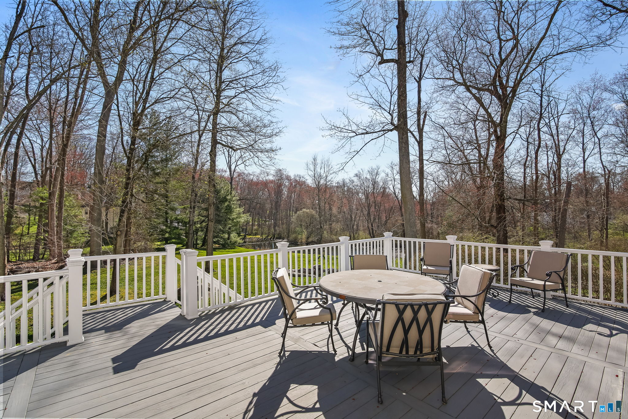 323 Smith Ridge Road New Canaan, CT 06840 - Photo 19 of 39 a view of a table and chairs on the roof deck