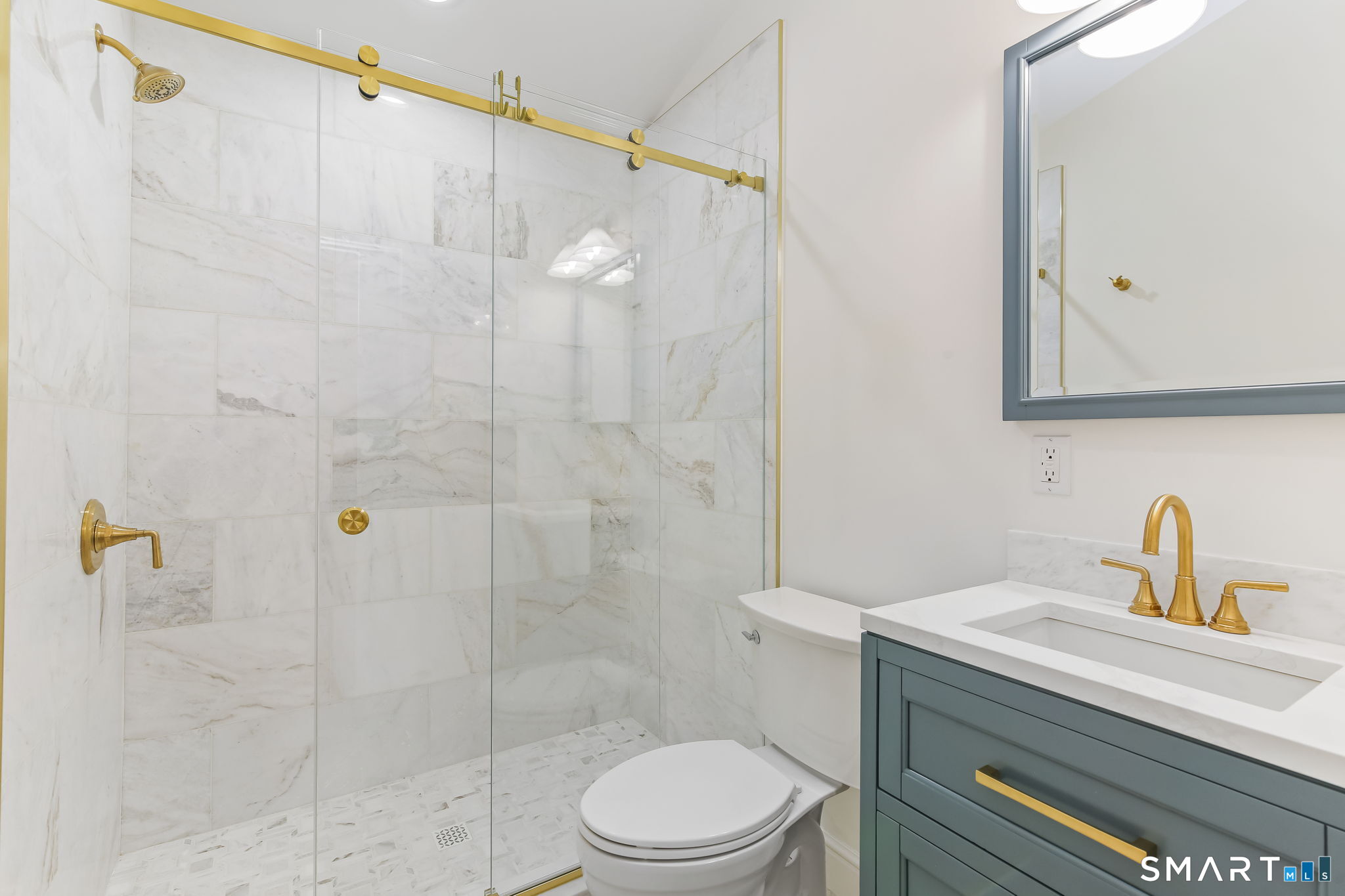 323 Smith Ridge Road New Canaan, CT 06840 - Photo 21 of 39 a bathroom with a sink a toilet and shower