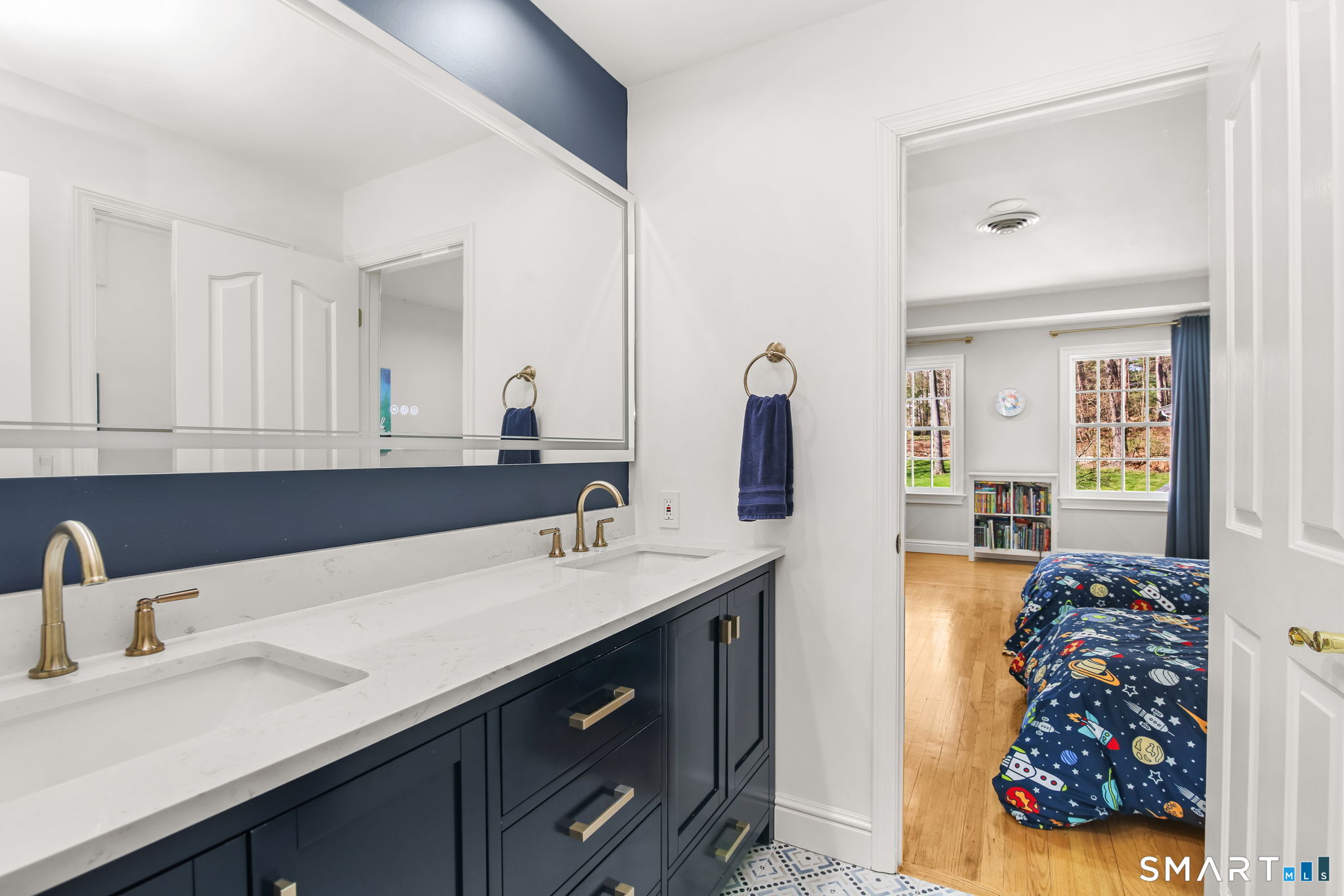 323 Smith Ridge Road New Canaan, CT 06840 - Photo 27 of 39 a bathroom with a sink double vanity and a mirror