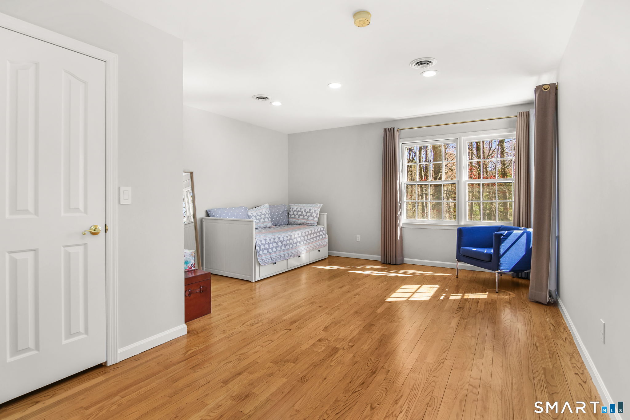 323 Smith Ridge Road New Canaan, CT 06840 - Photo 28 of 39 a view of an empty room with a window and wooden floor