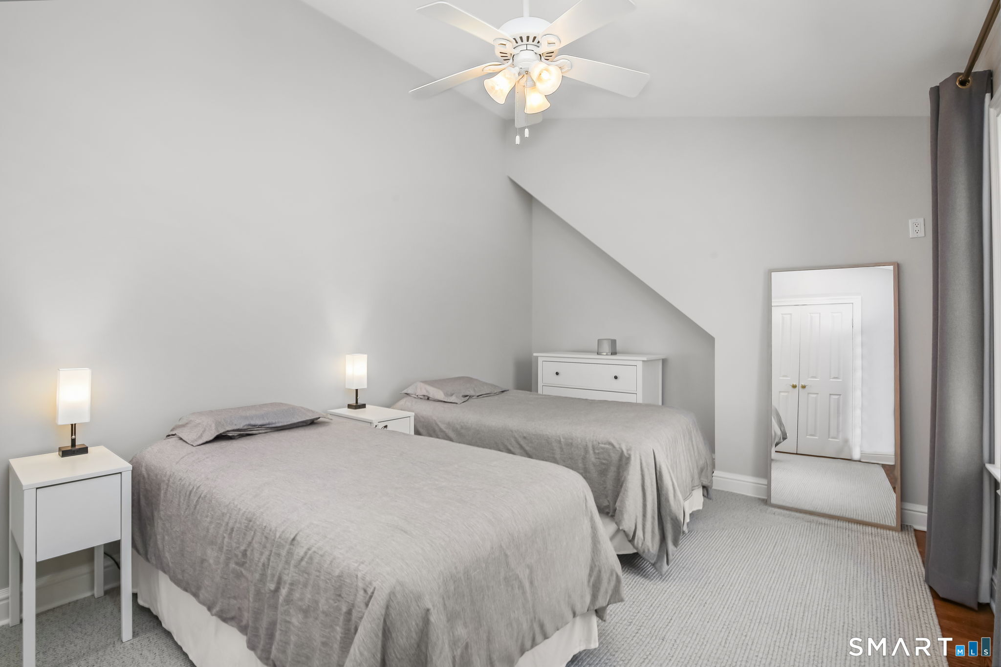 323 Smith Ridge Road New Canaan, CT 06840 - Photo 34 of 39 a bedroom with a bed and a chandelier