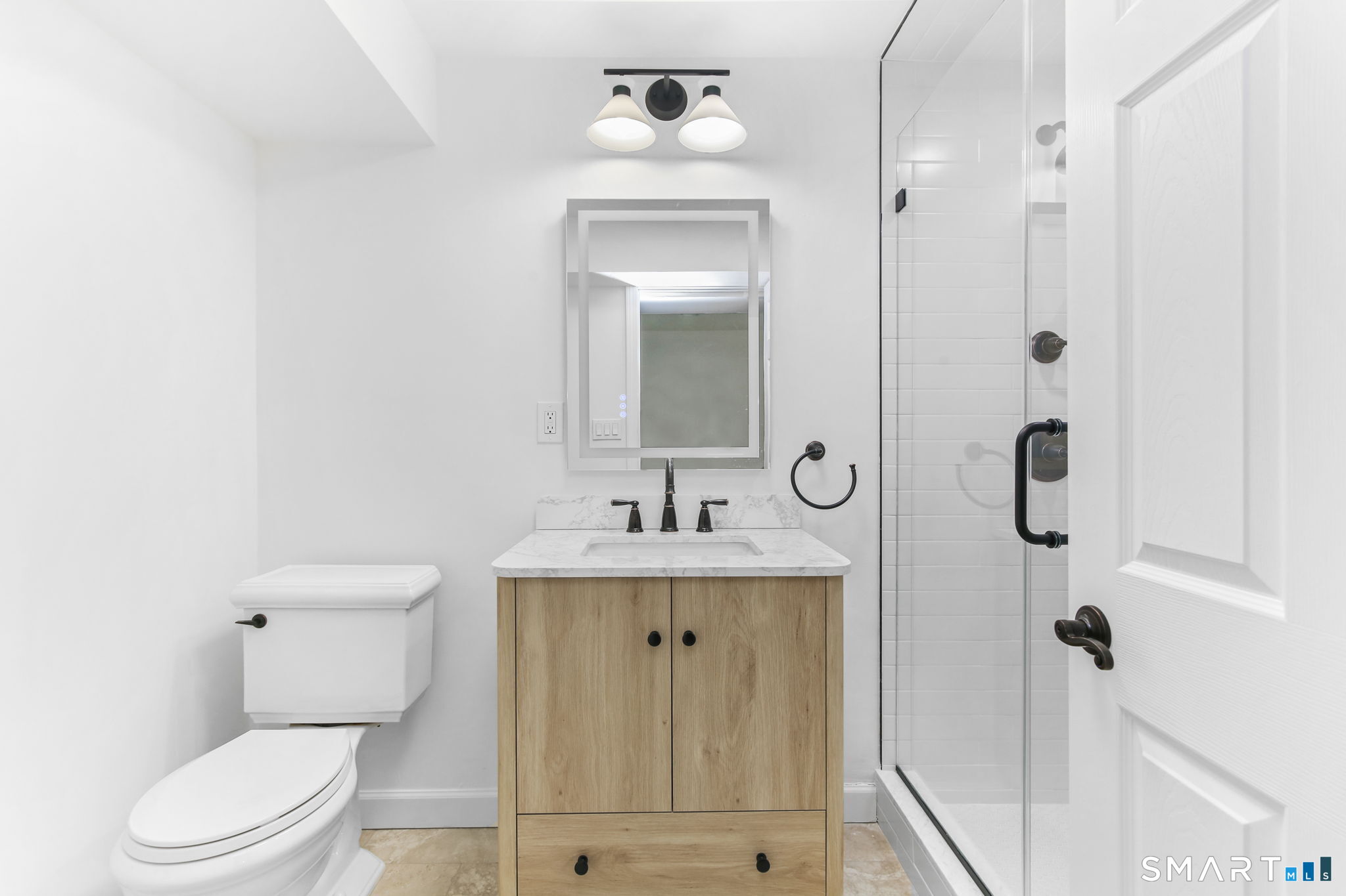 323 Smith Ridge Road New Canaan, CT 06840 - Photo 36 of 39 a bathroom with a toilet sink and shower