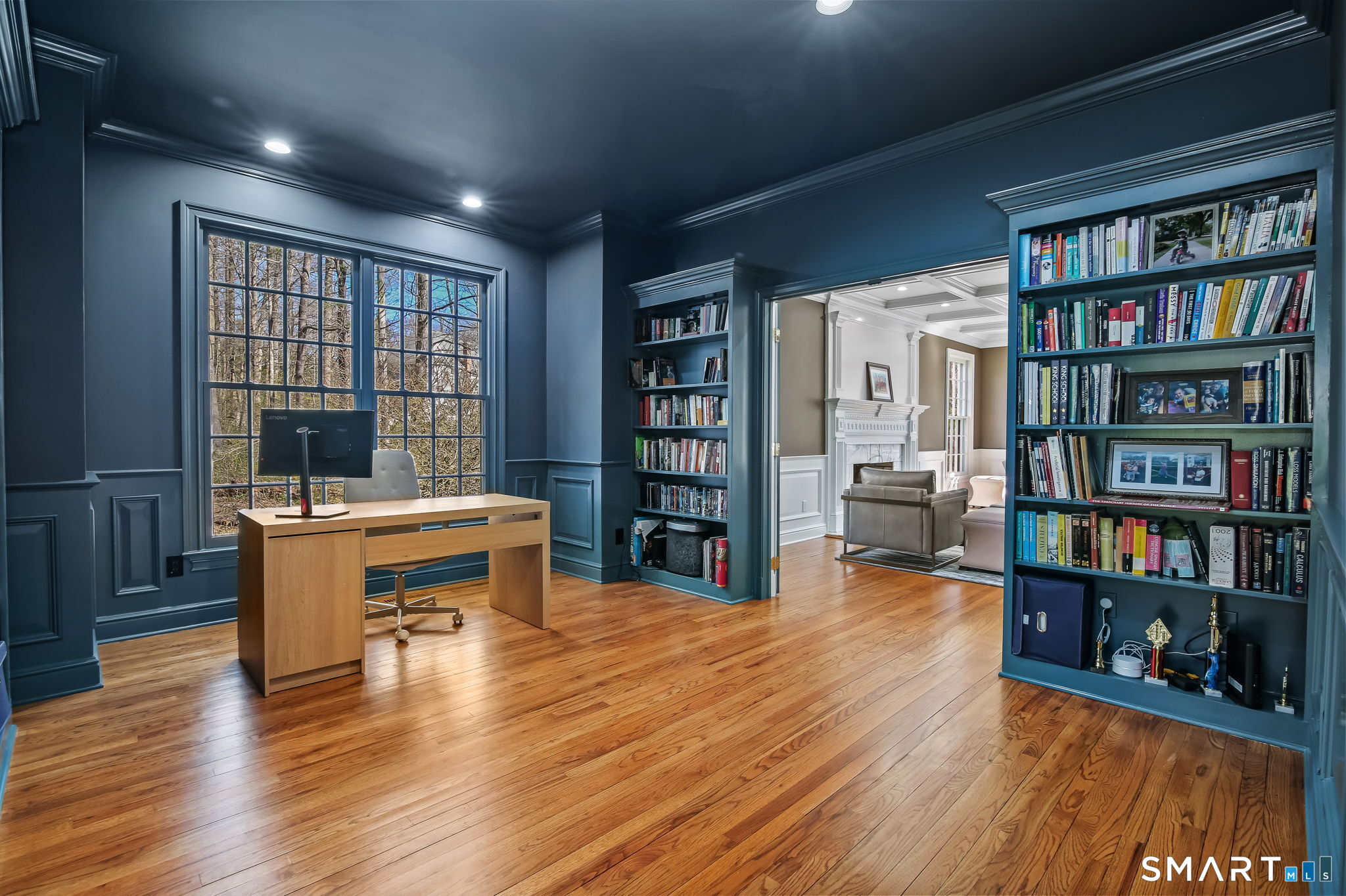 323 Smith Ridge Road New Canaan, CT 06840 - Photo 8 of 39 a living room with furniture and a book shelf