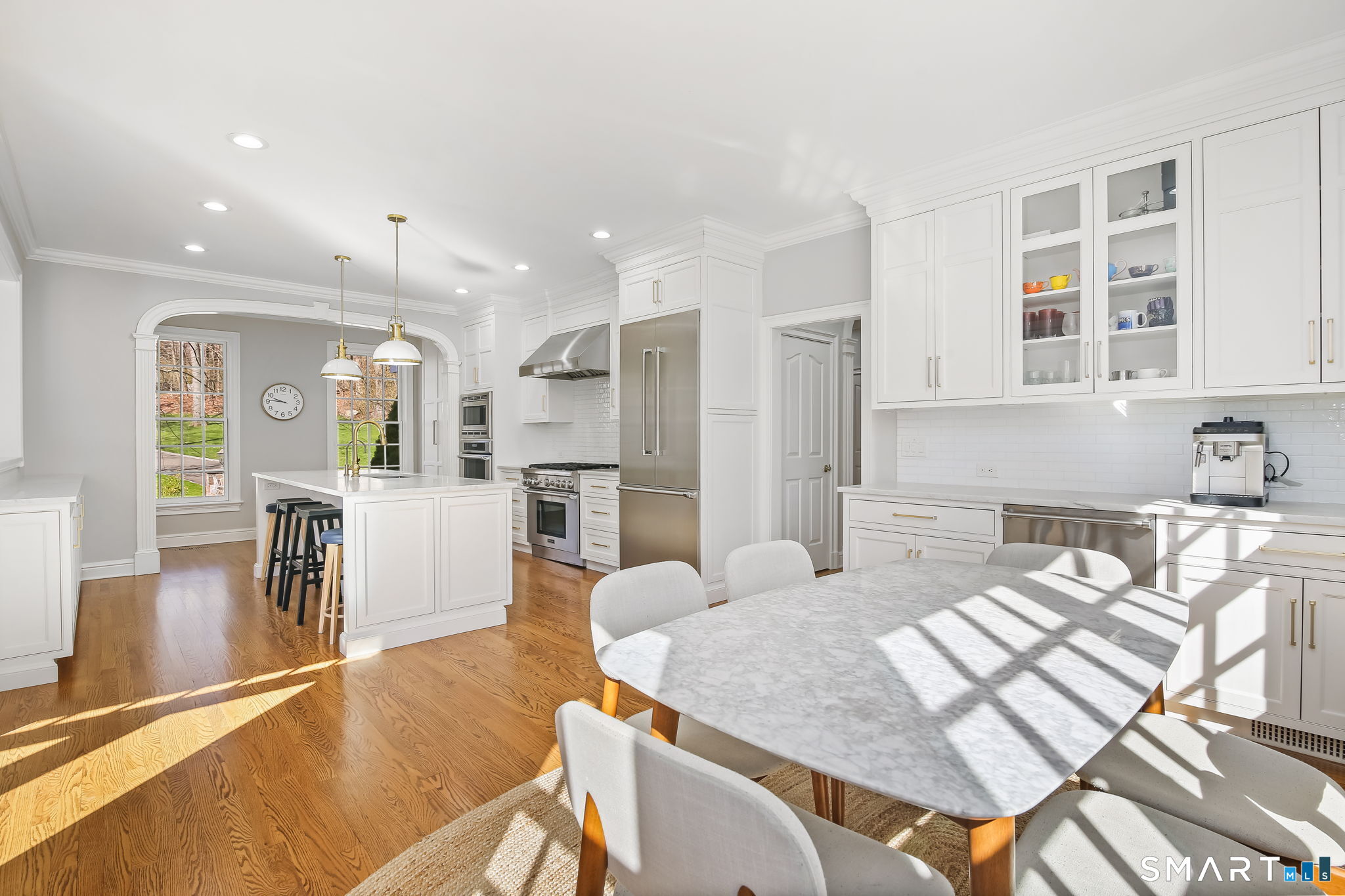 323 Smith Ridge Road New Canaan, CT 06840 - Photo 10 of 39 a large kitchen with kitchen island a large counter top stainless steel appliances and cabinets