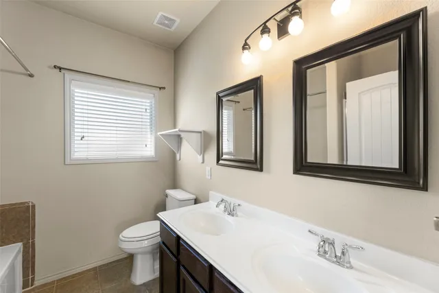 a bathroom with 2 sink and a toilet